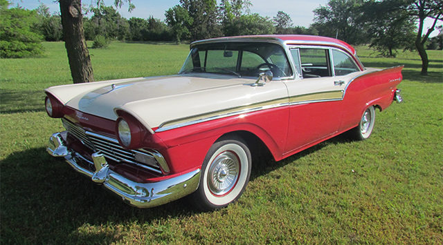 Three McPherson College students and a staff member are entering a red-and-white 1957 Ford Fairlane.